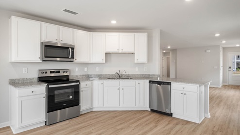Kitchen with granite countertops and stainless-steel appliances.