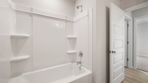 Bathroom with EVP flooring and shower tub combo.
