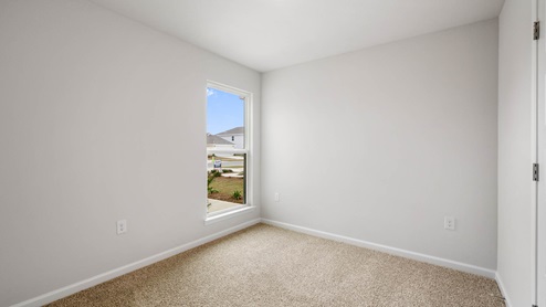 Bedroom with closet and carpet floor and window.