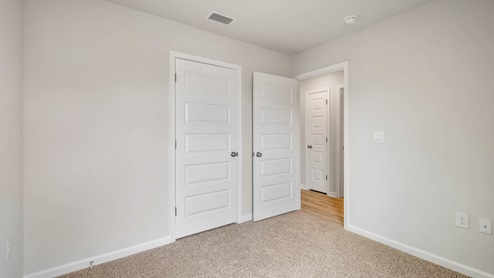 Bedroom with closet and carpet floor.
