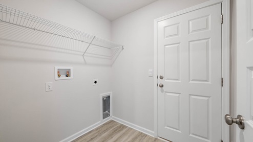 Laundry room with ventilated shelving.