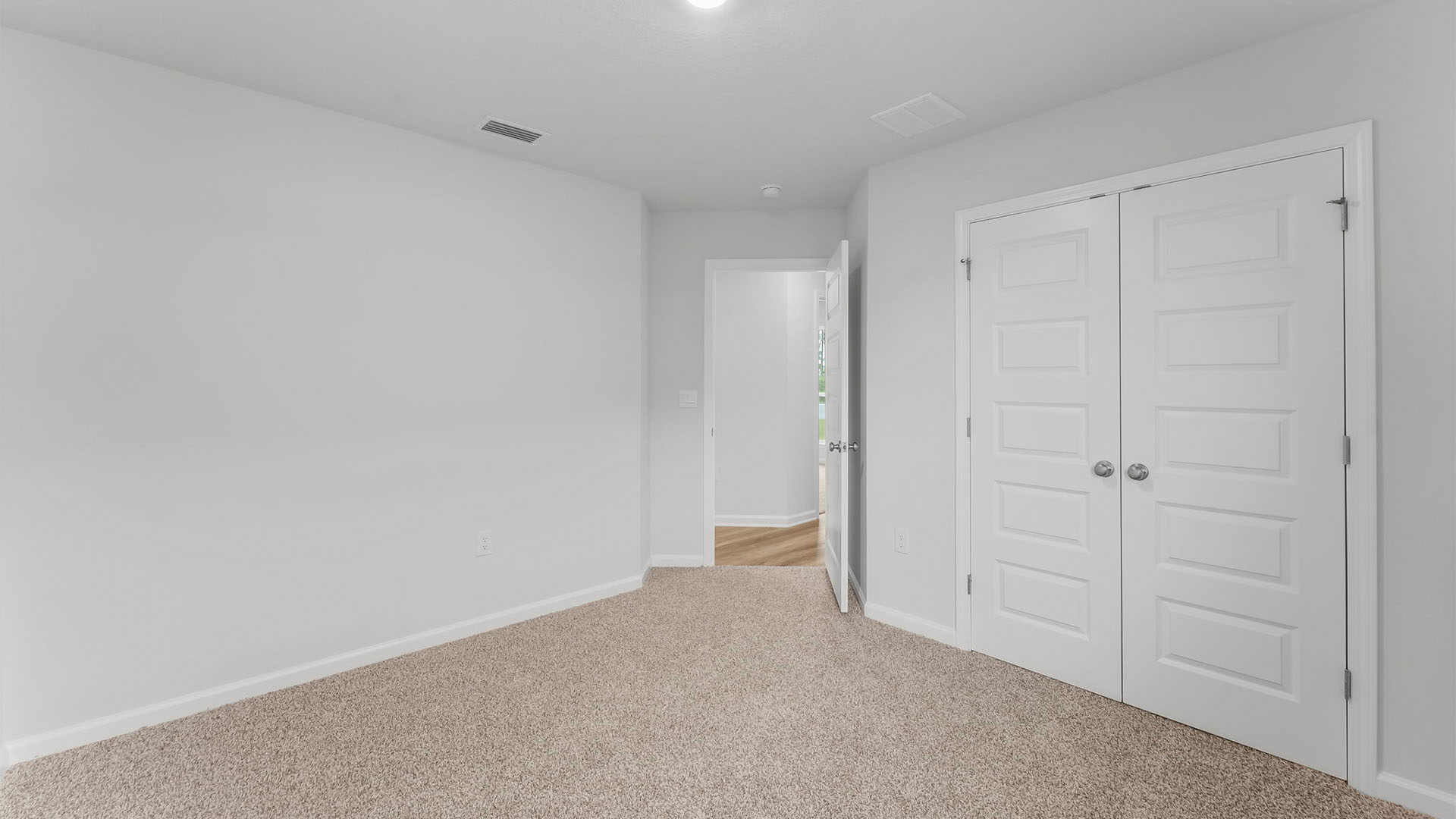 Bedroom with closet and carpet floor.
