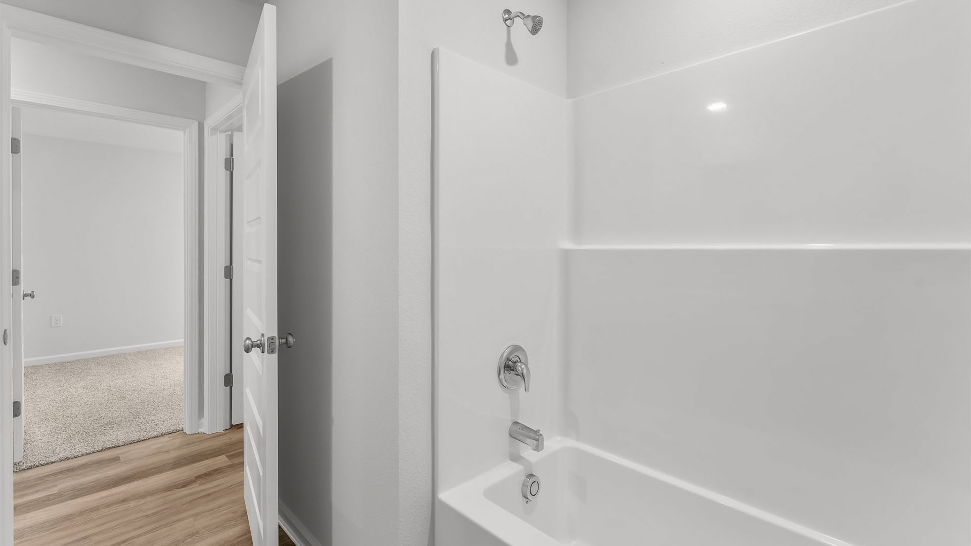 Bathroom with EVP flooring and shower tub combo.