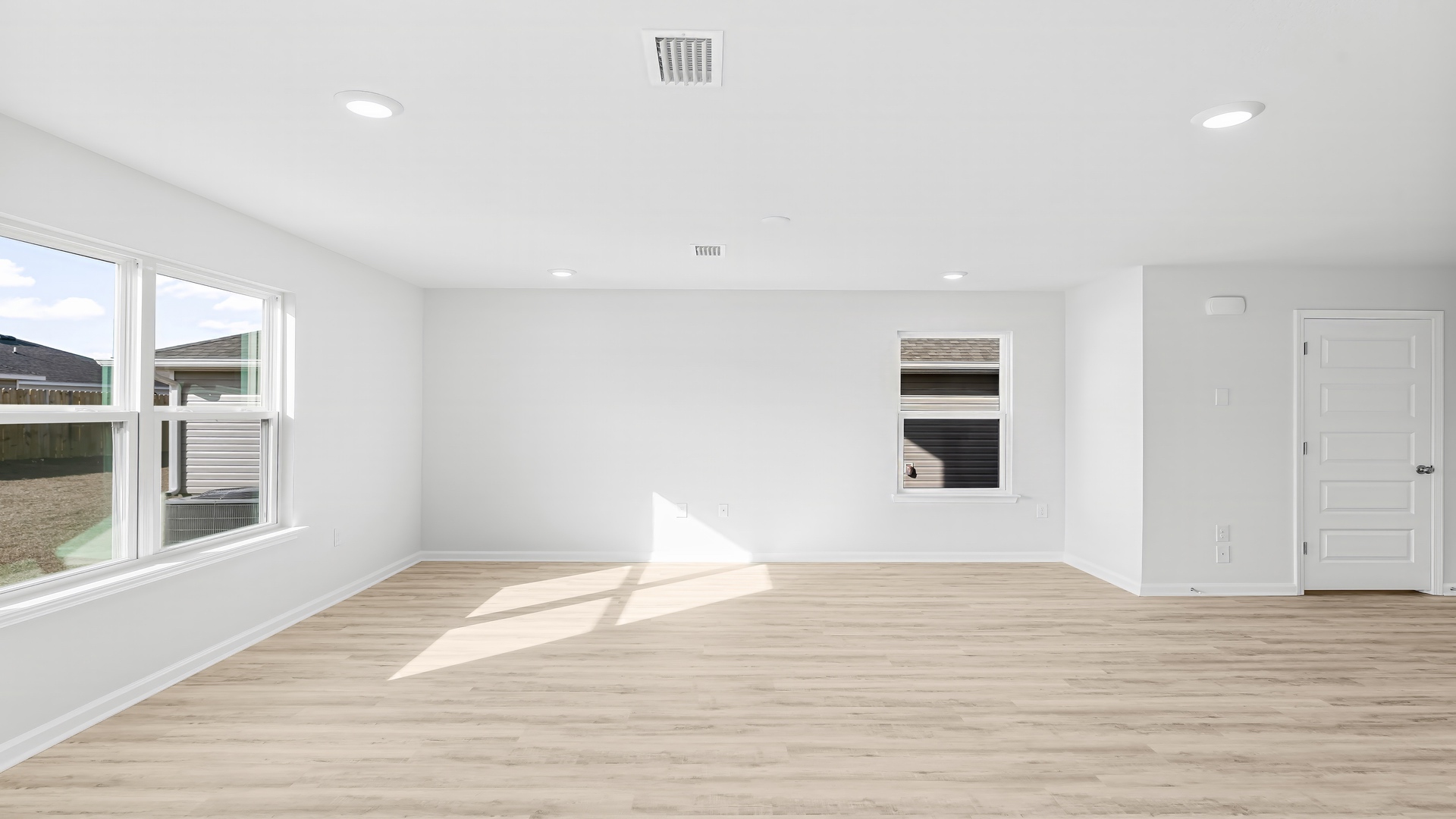 Open living room with EVP flooring and bathroom by front door.