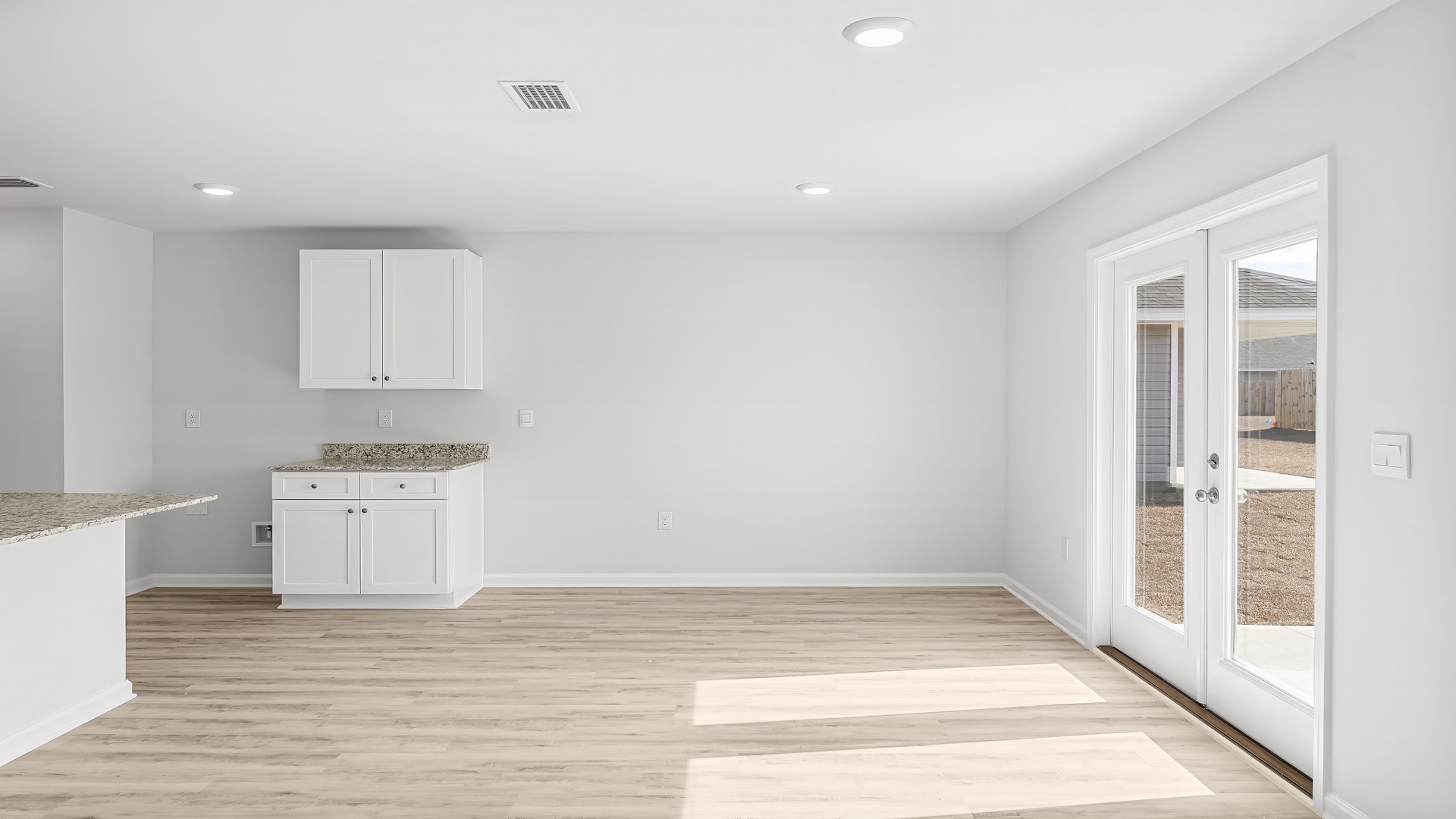 Dining area next to back door and kitchen island.