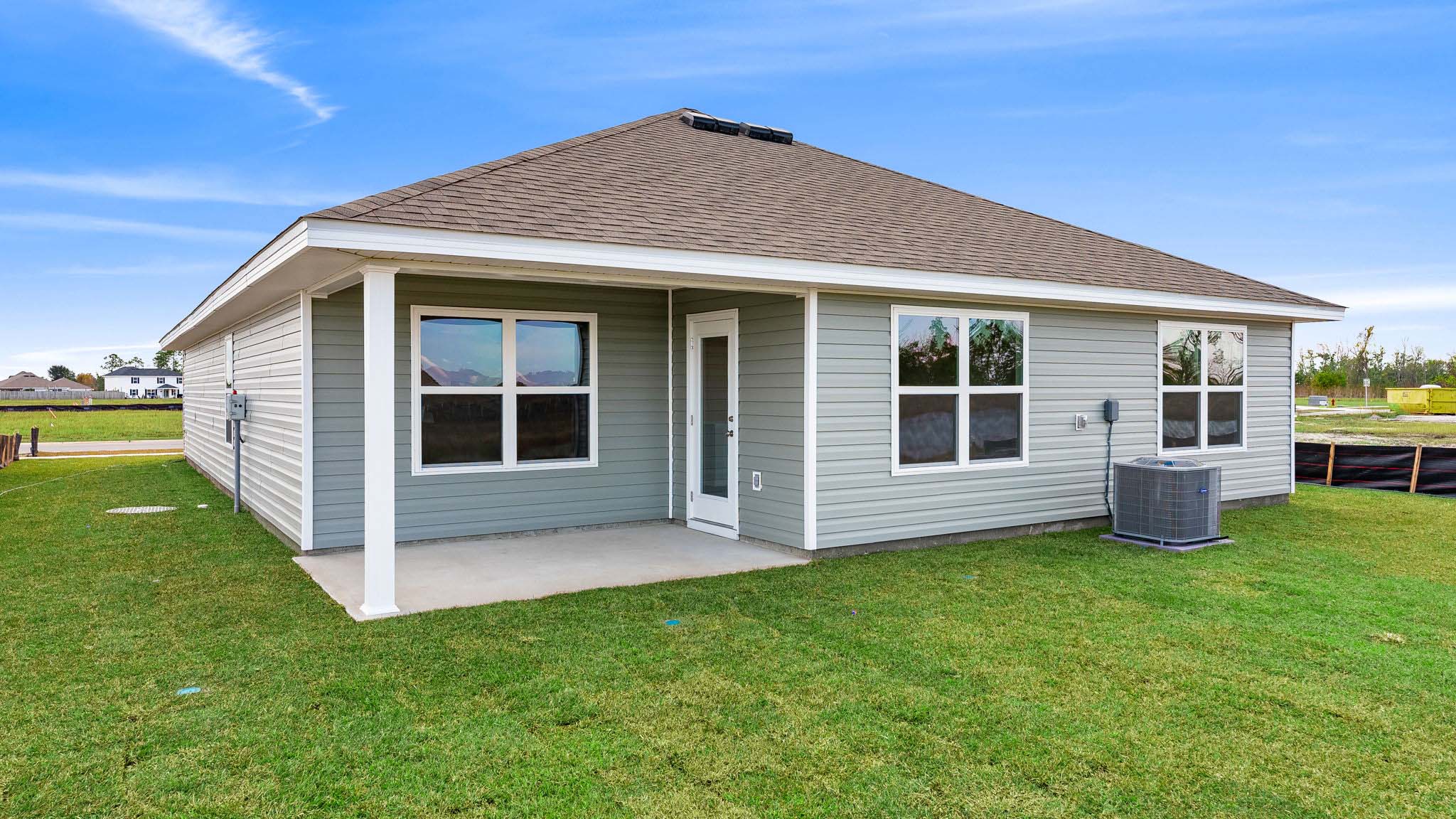 Aria plan rear of home with vinyl siding and covered patio.
