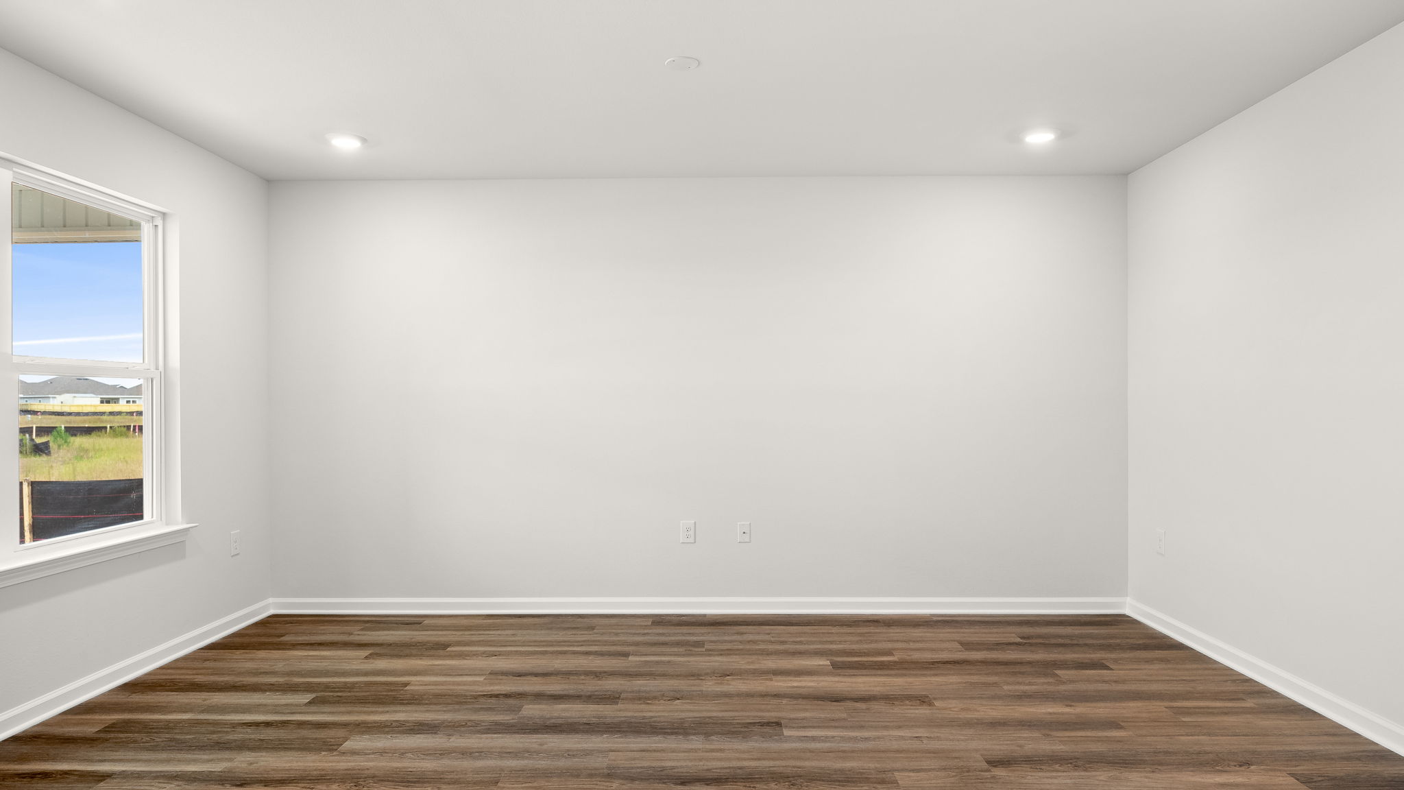 Living room view with EVP flooring and windows.