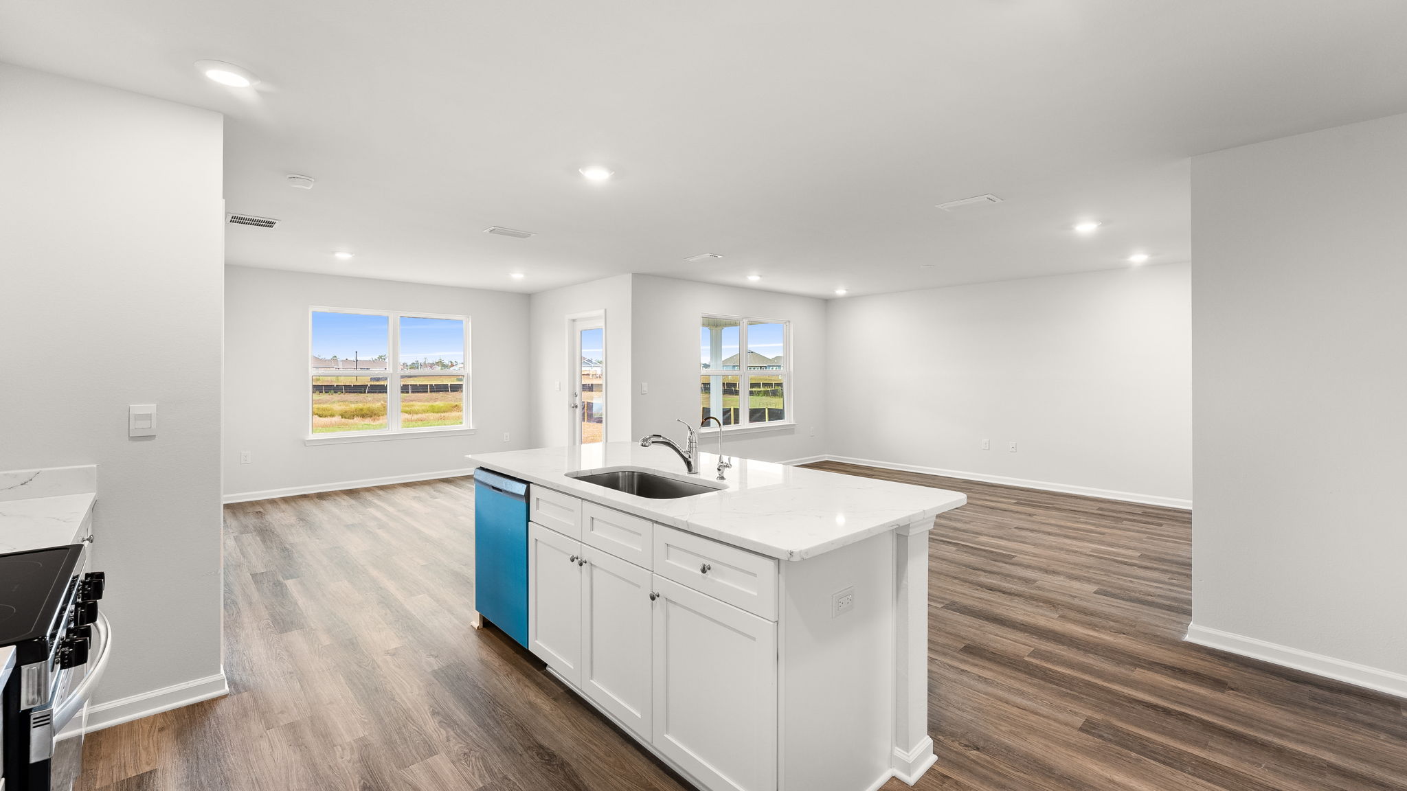 Kitchen and living room view with island from pantry.