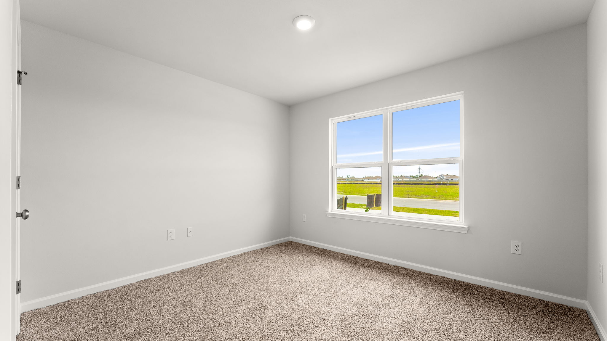 Bedroom with carpet floor and windows and closet.