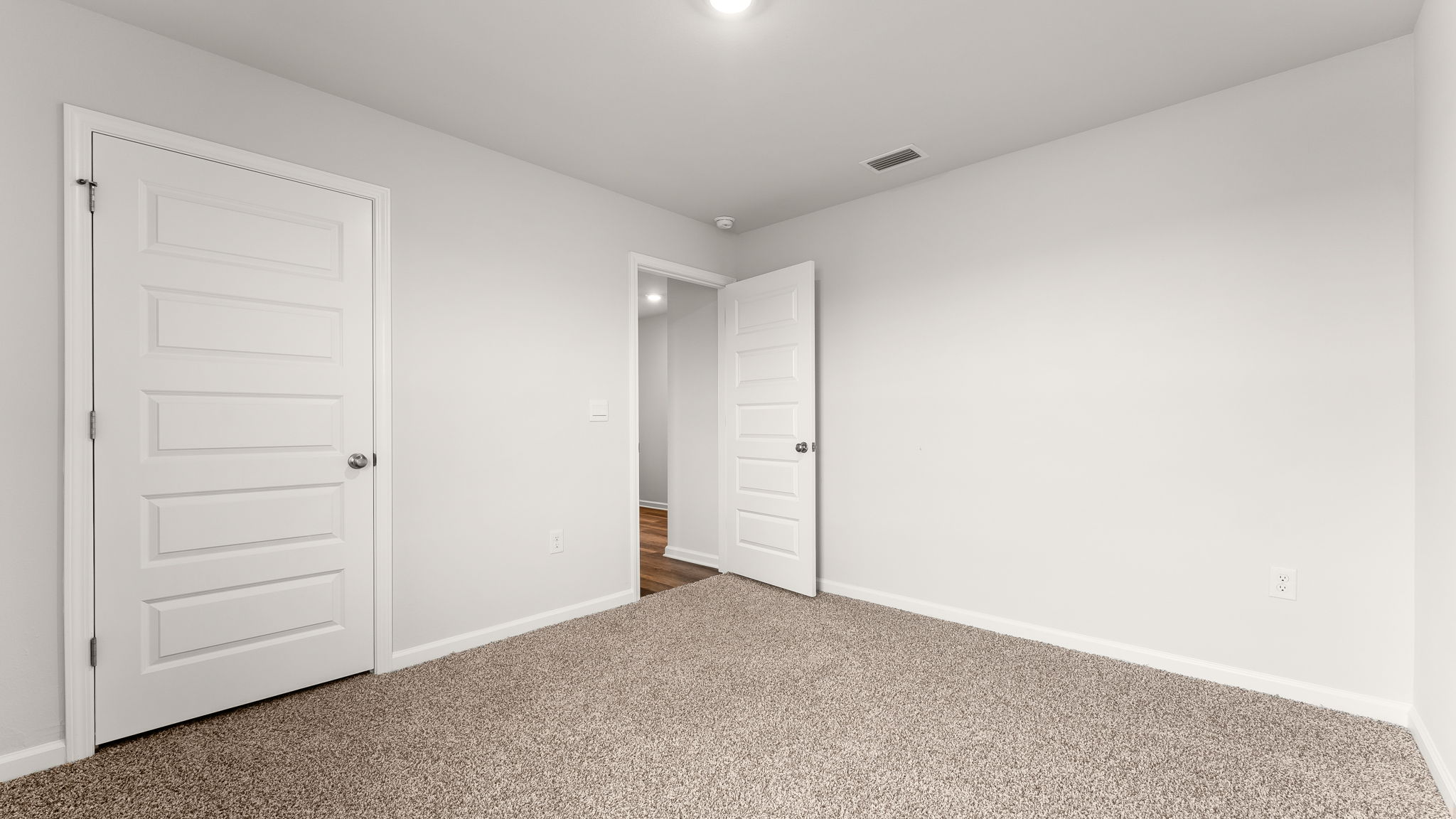 Bedroom with carpet floor and closet.