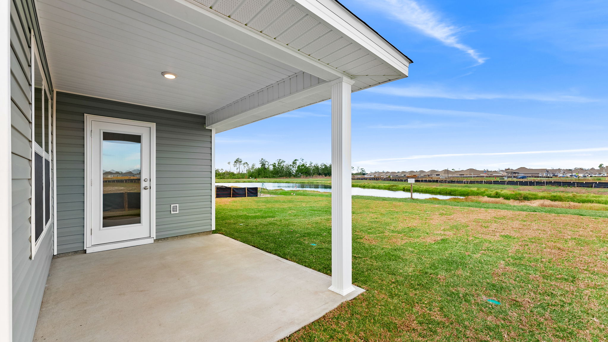 Covered back patio and back yard view.