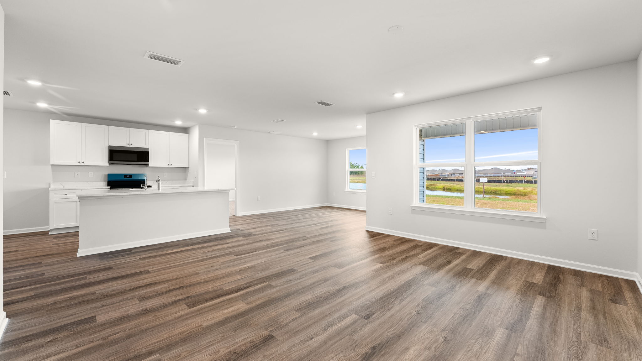 Living room view of kitchen and dining area.