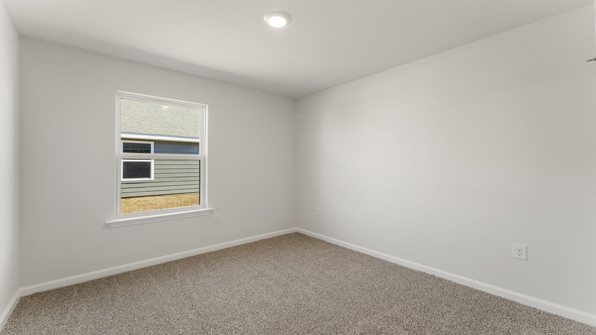Bedroom with carpet floor and window.