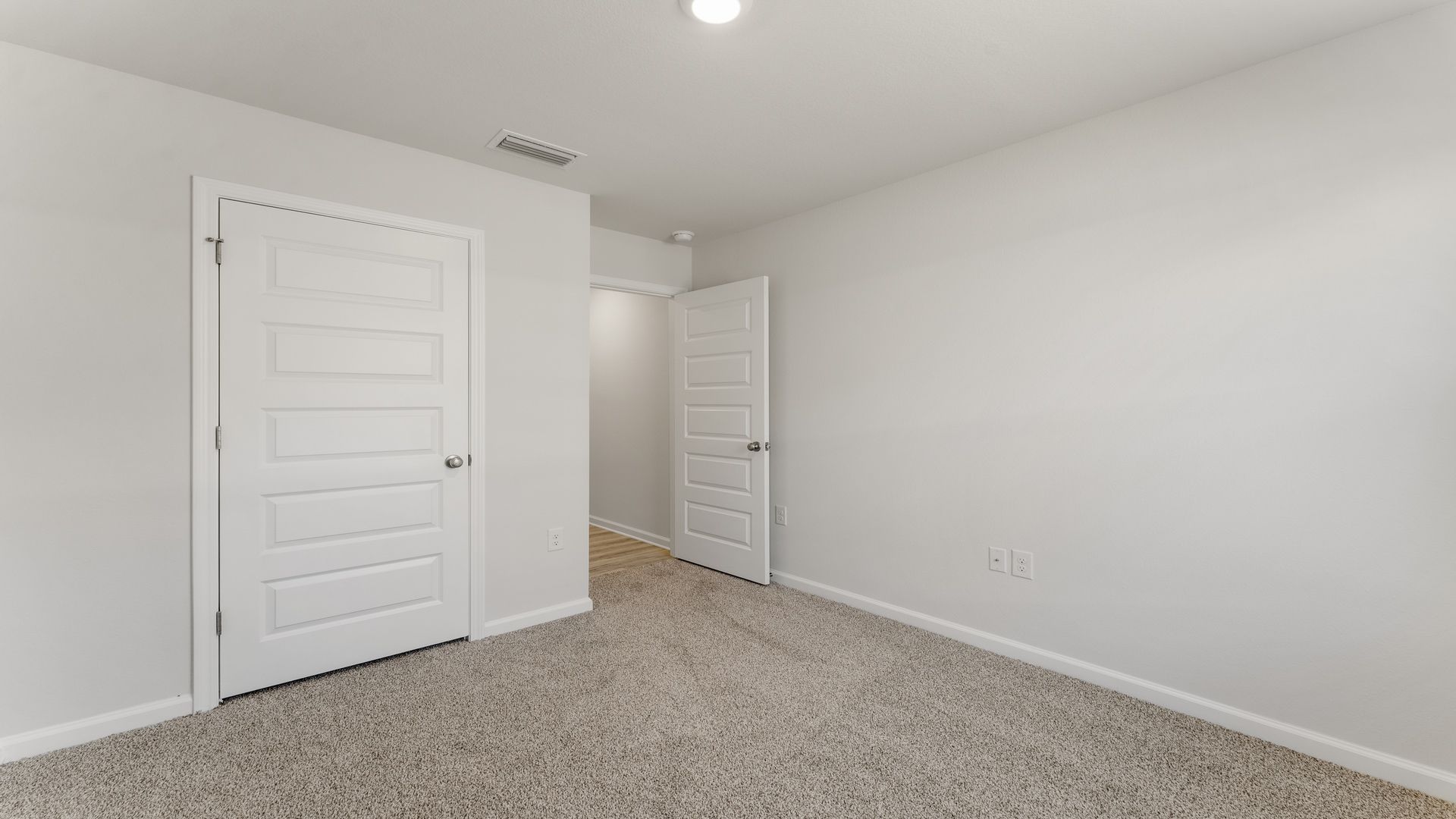 Bedroom with carpet floor and closet.