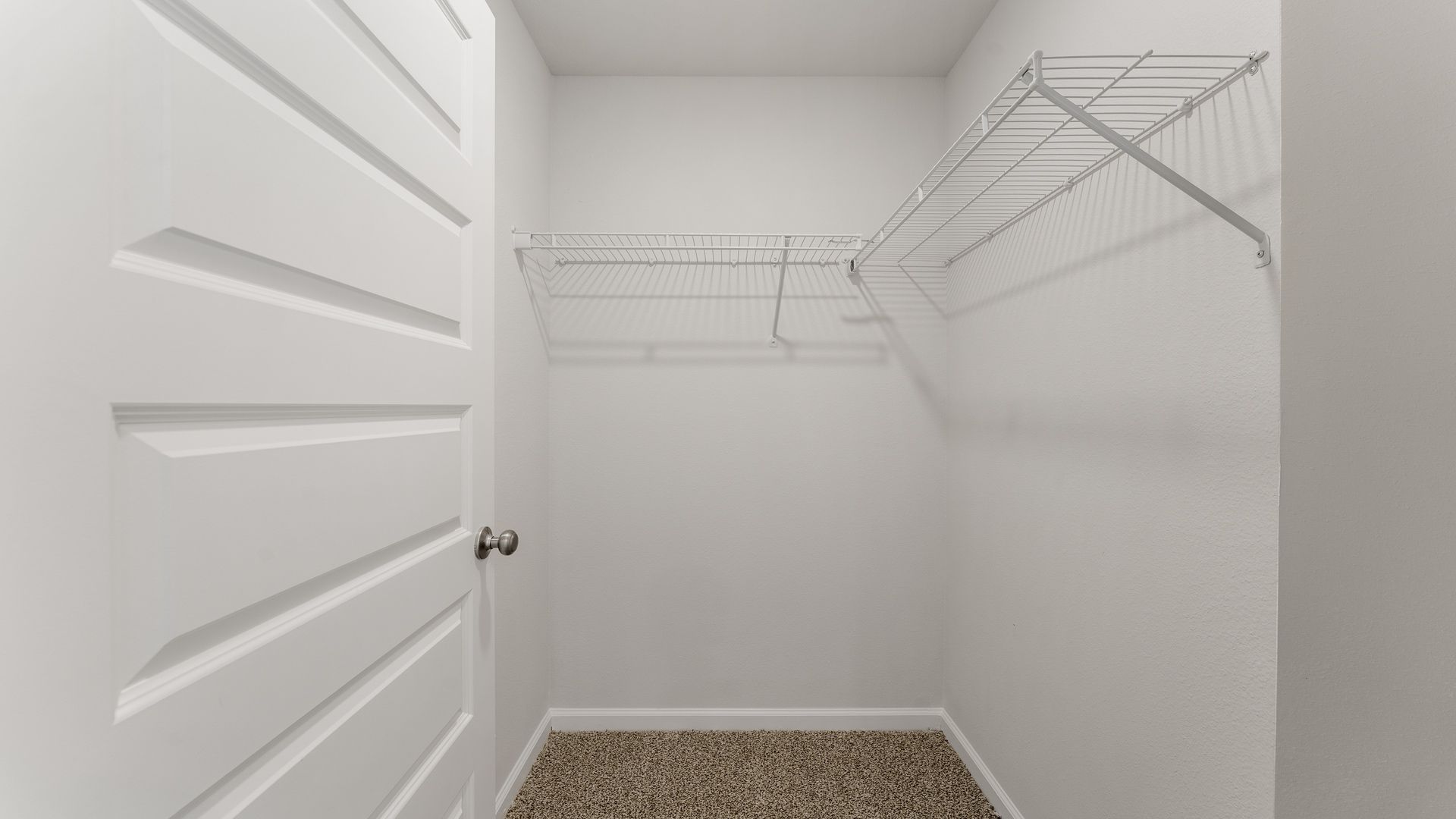 Walk-in closet with ventilated shelving.