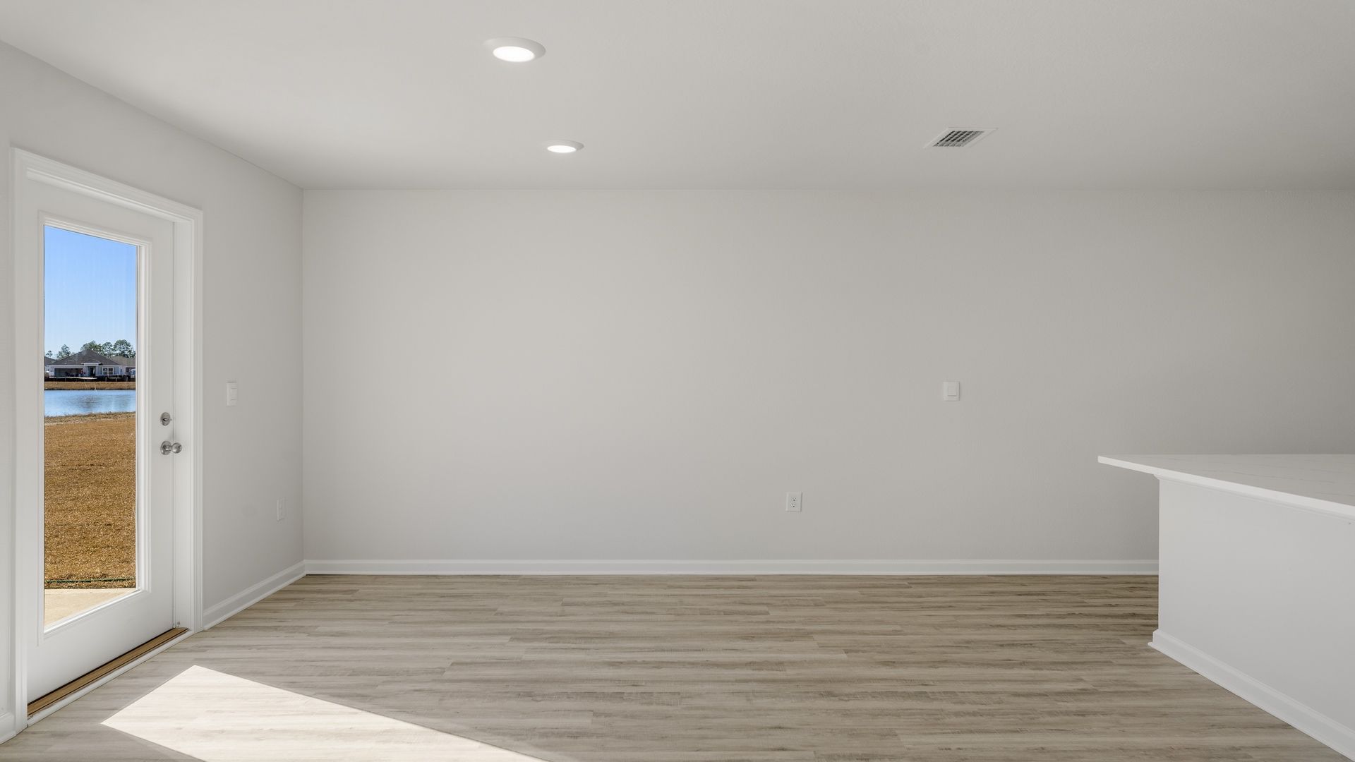 Dining area with back door and kitchen island.