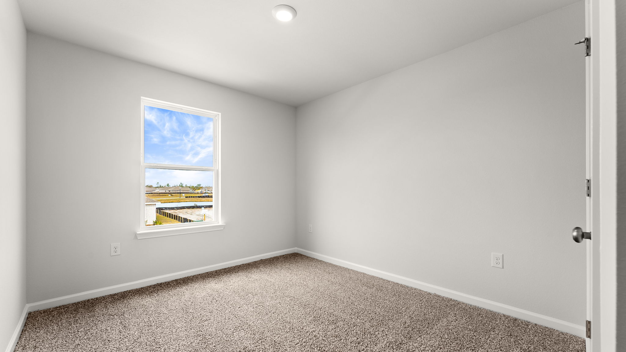 Bedroom with carpet floor and window and closet.