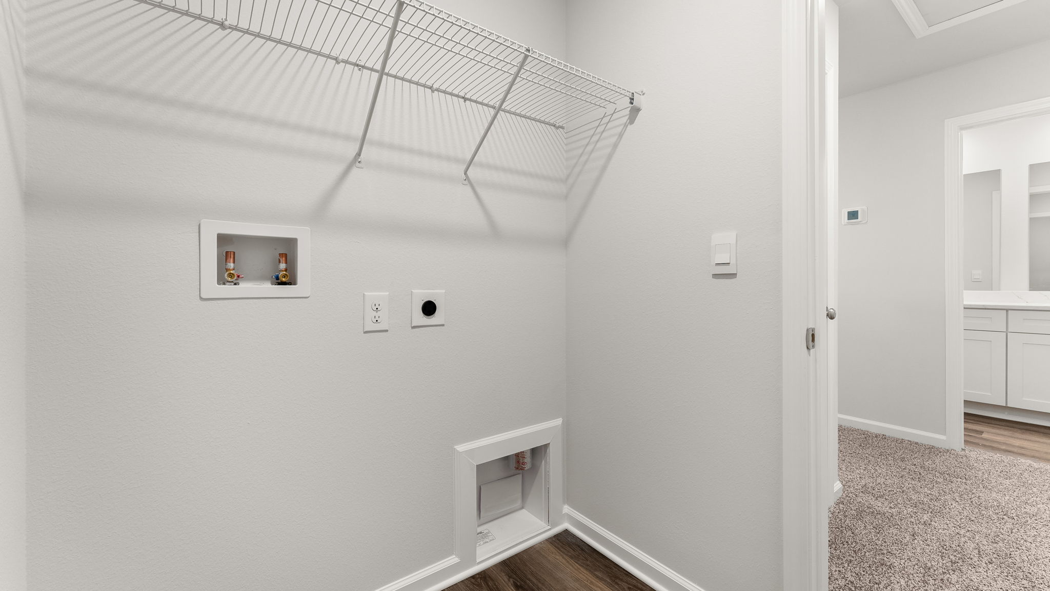 Laundry room with ventilated shelving.