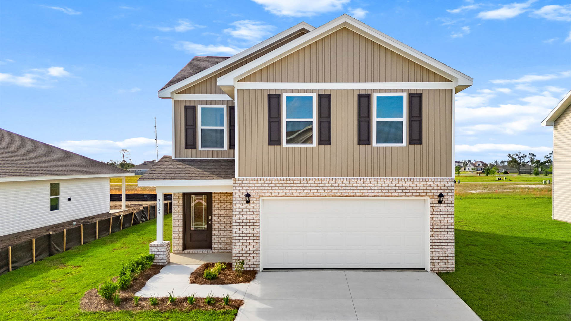 Taylor plan at Hodges Bayou Plantation with brick front and vinyl siding and two-car garage.