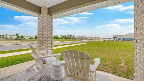Hodges Bayou Plantation model home covered patio and yard.