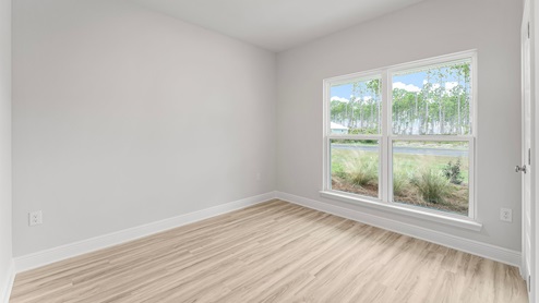 Bedroom with EVP flooring and window.