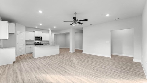 Living room with ceiling fan and EVP flooring.