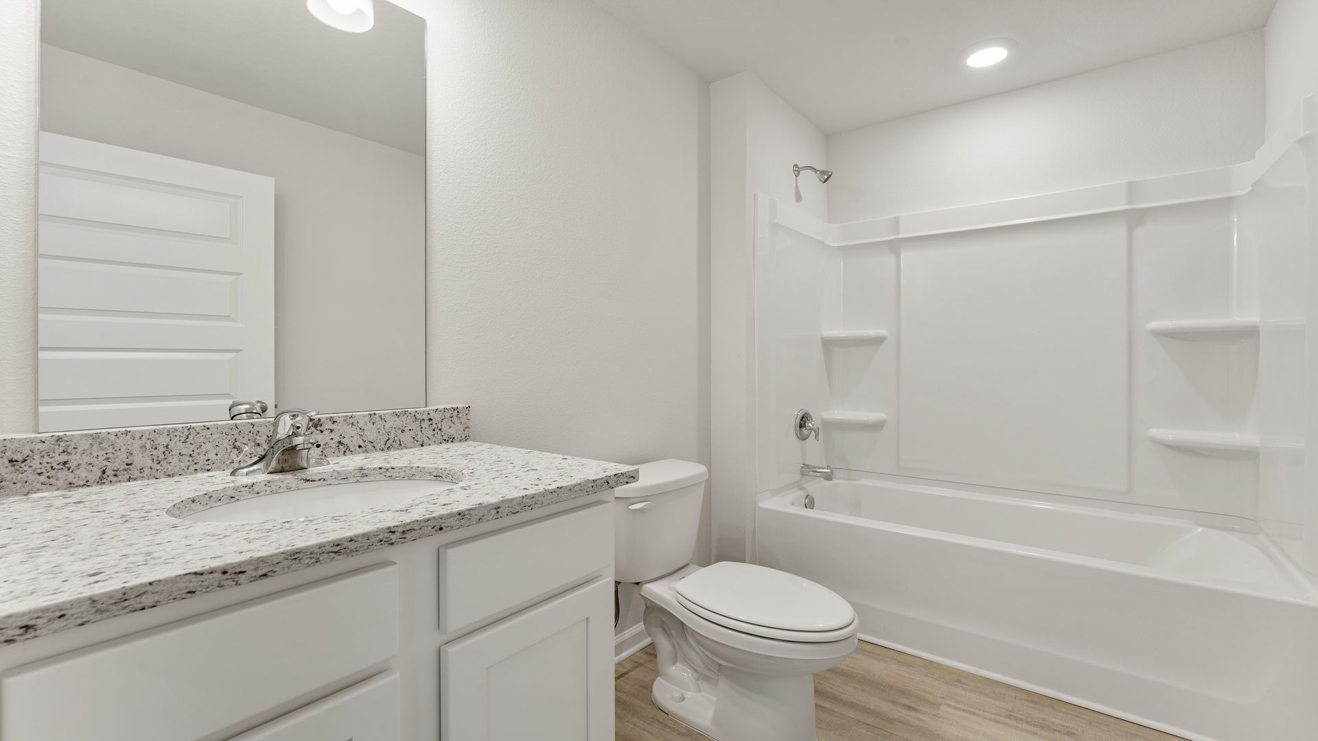 Bathroom with single vanity granite countertops and toilet and tub and shower.