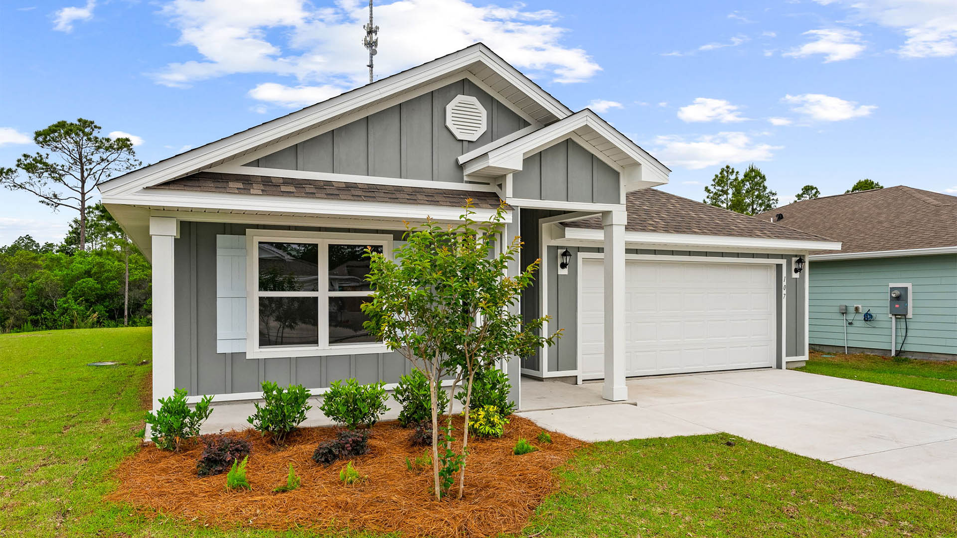 Cali floor plan at Palmetto Bluff with Hardie Board siding and 2 car garage and covered front porch.