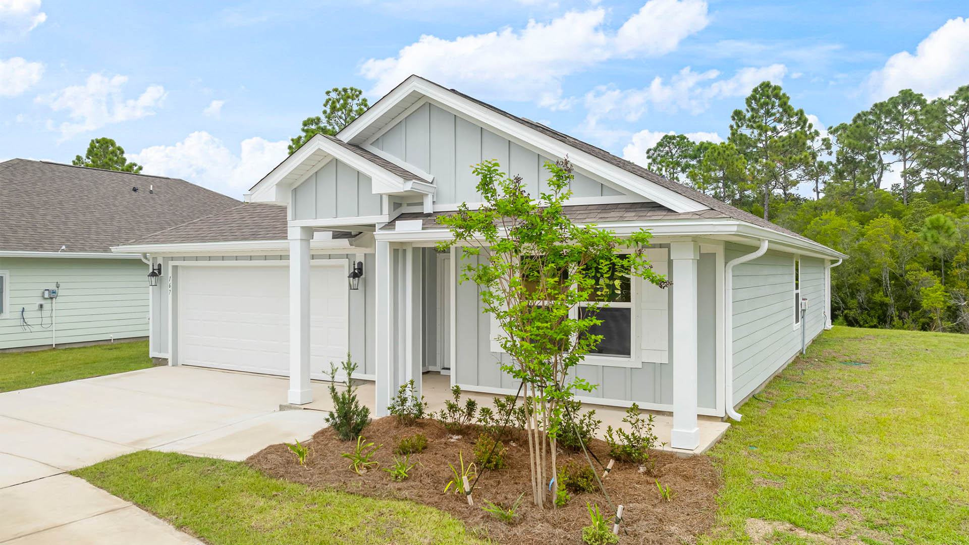 Cali floor plan at Palmetto Bluff with Hardie Board siding and 2 car garage and covered front porch.