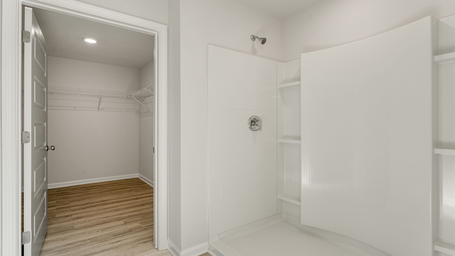 Primary bathroom with double vanity granite countertops and separate tub.