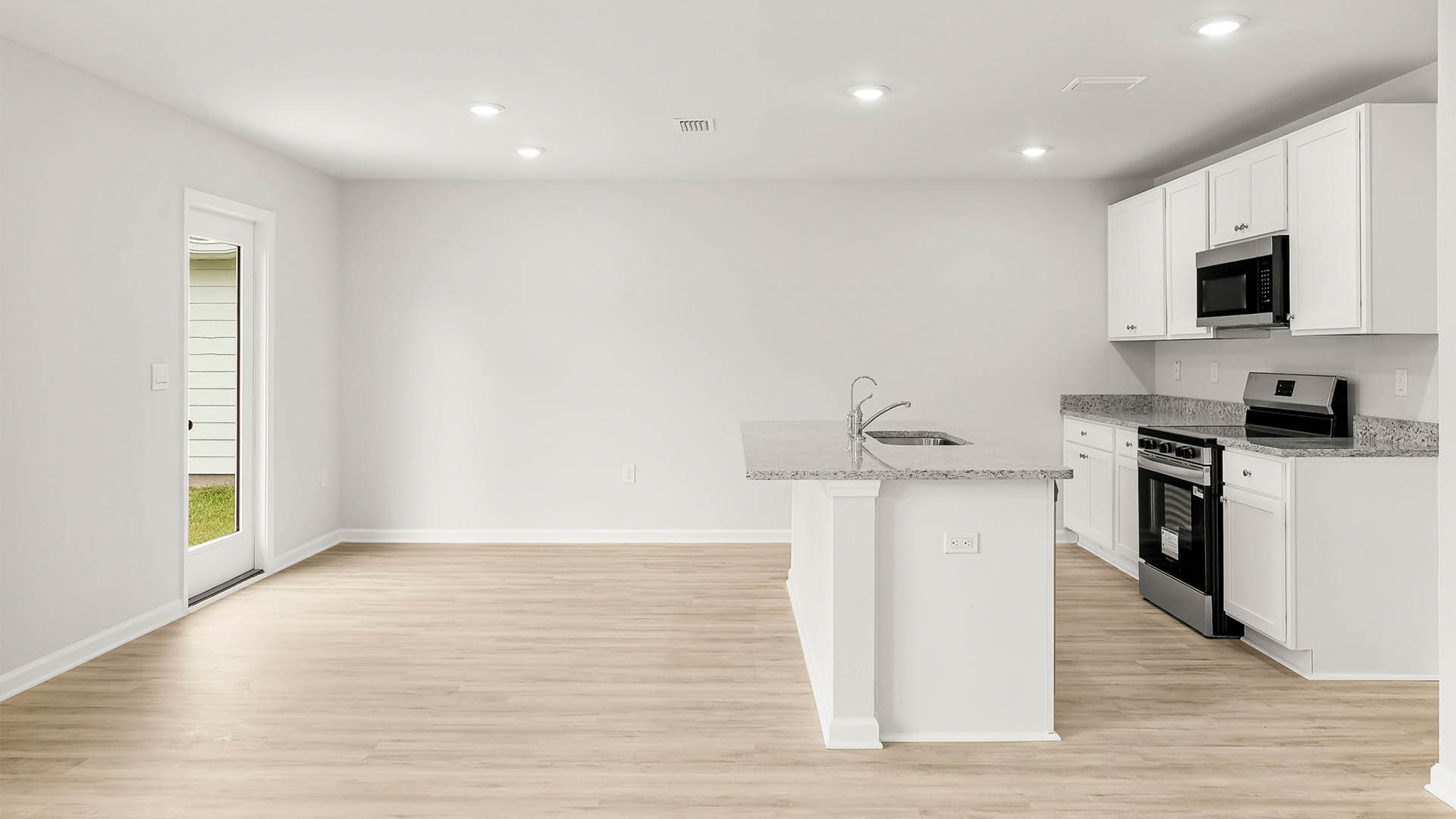Dining area and kitchen next to back door.