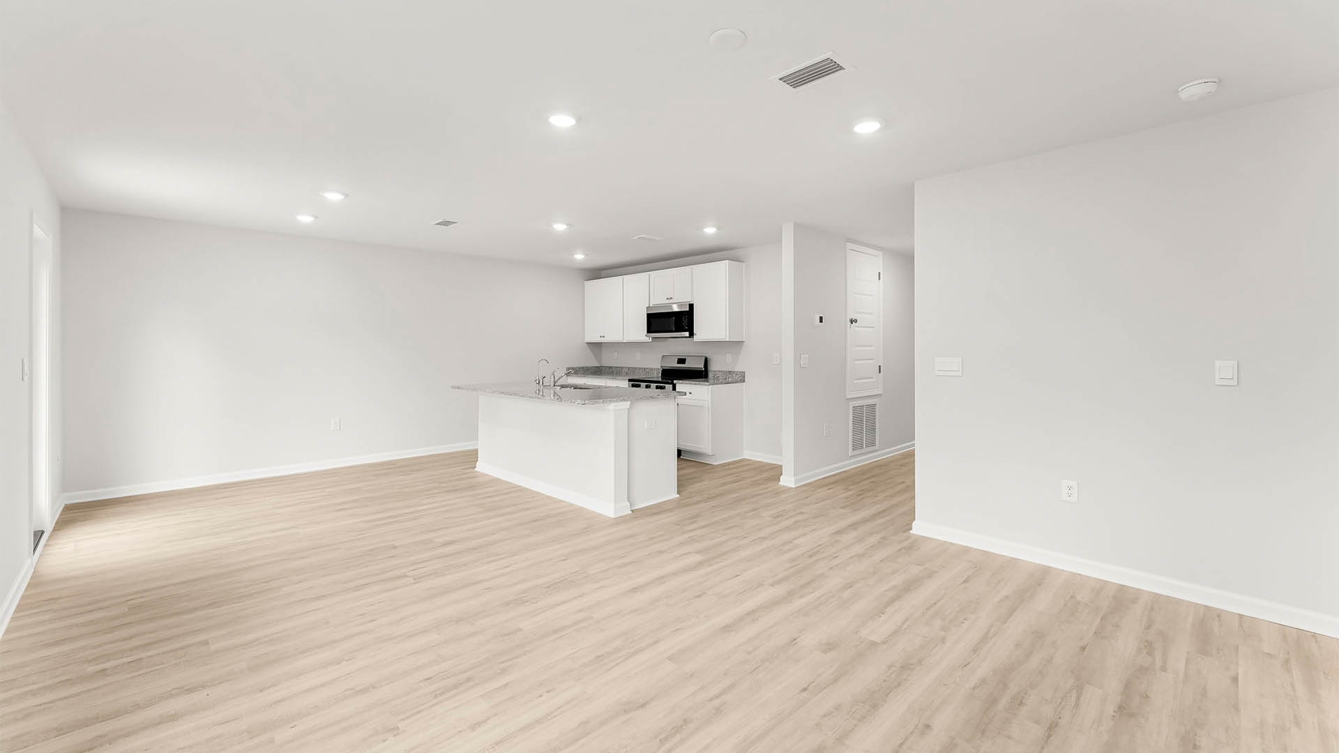 Living room view of kitchen and dining area.