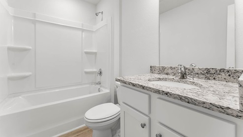 Bathroom with granite countertops and single vanity and shower and tub.