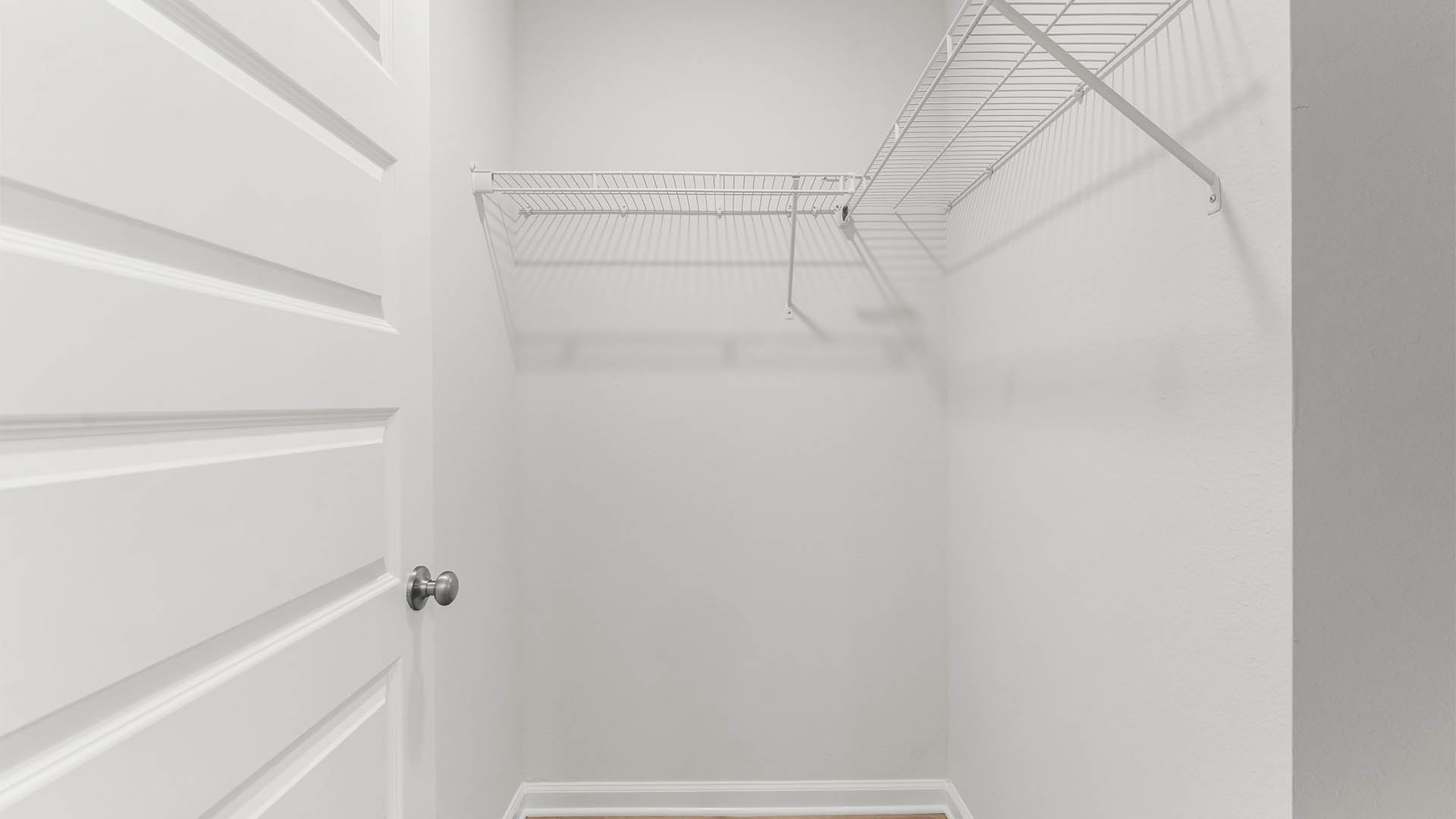 Walk-in closet with ventilated shelving.