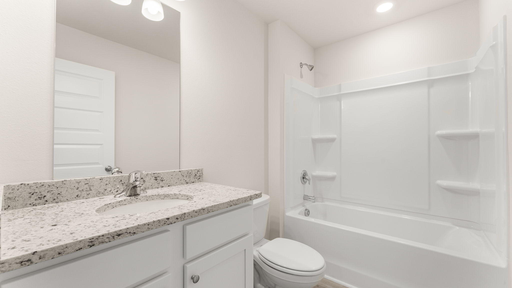 Bathroom with single vanity granite countertops and toilet and tub and shower.