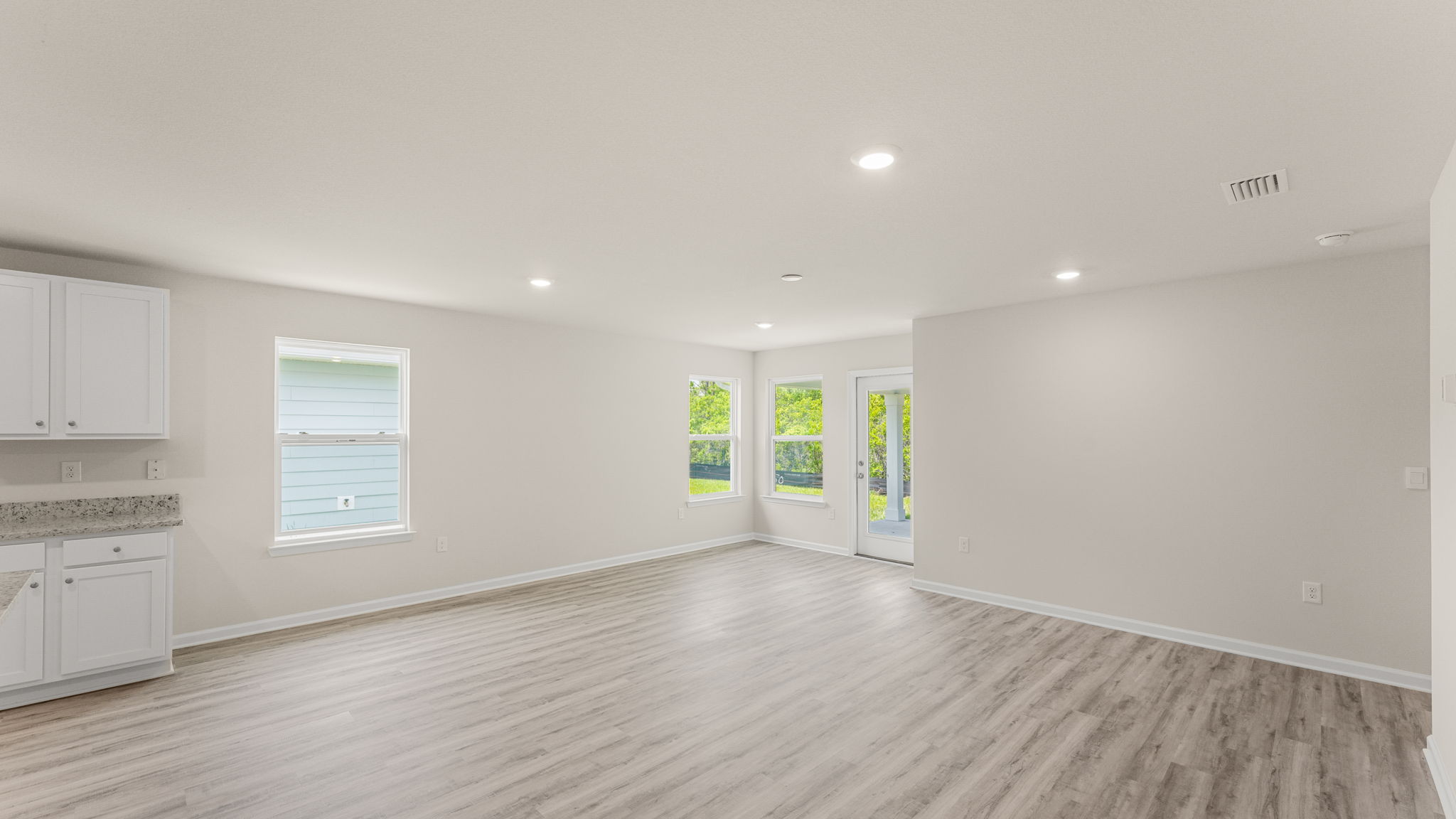 Open living room with EVP flooring and back door.