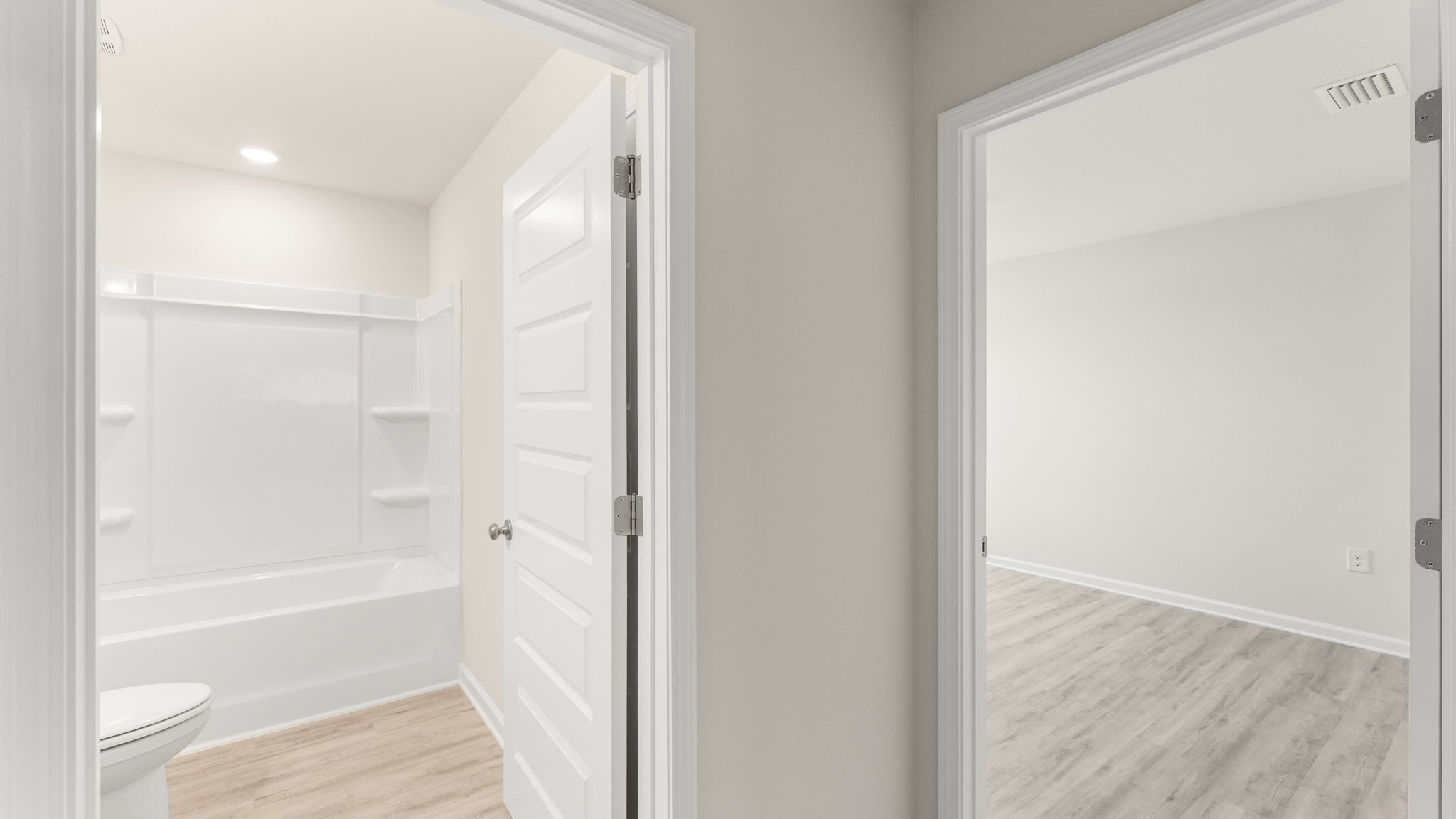 Hallway with bedroom and bathroom entrances.