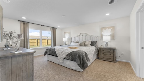 Primary bedroom with carpet floors.