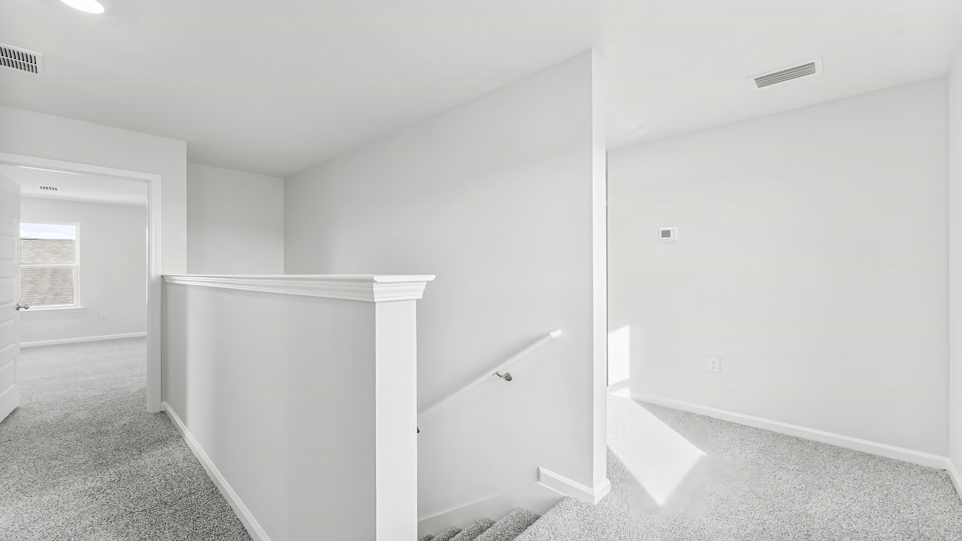 Upstairs foyer with carpet floors.