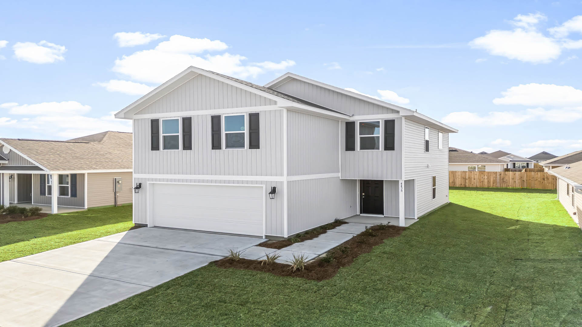Aisle model at Park Place front of home with vinyl siding and two-car garage.