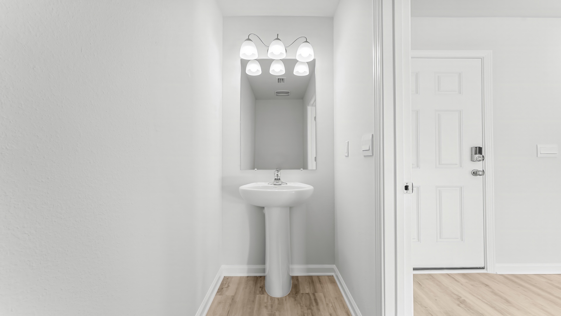 Bathroom with sink and mirror by front door.