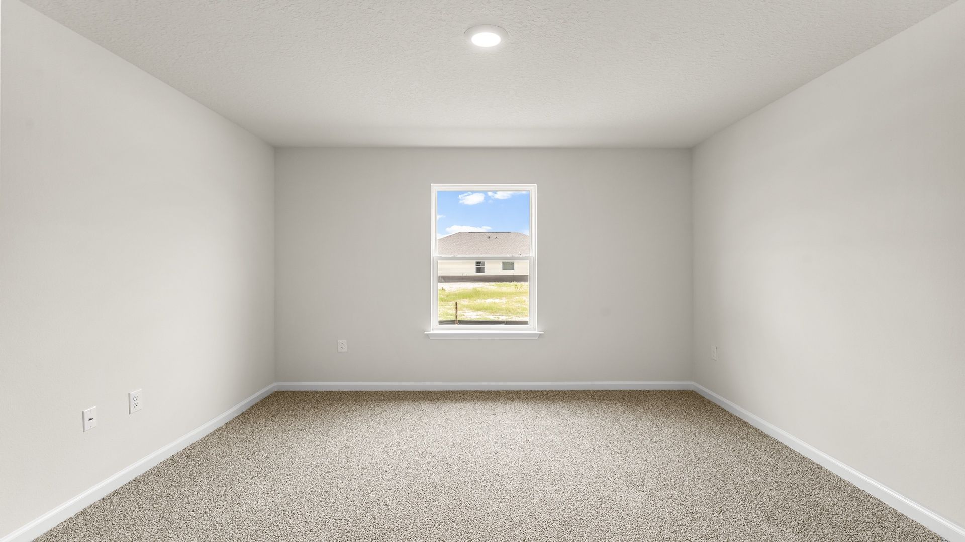 Bedroom with carpet floors and window.