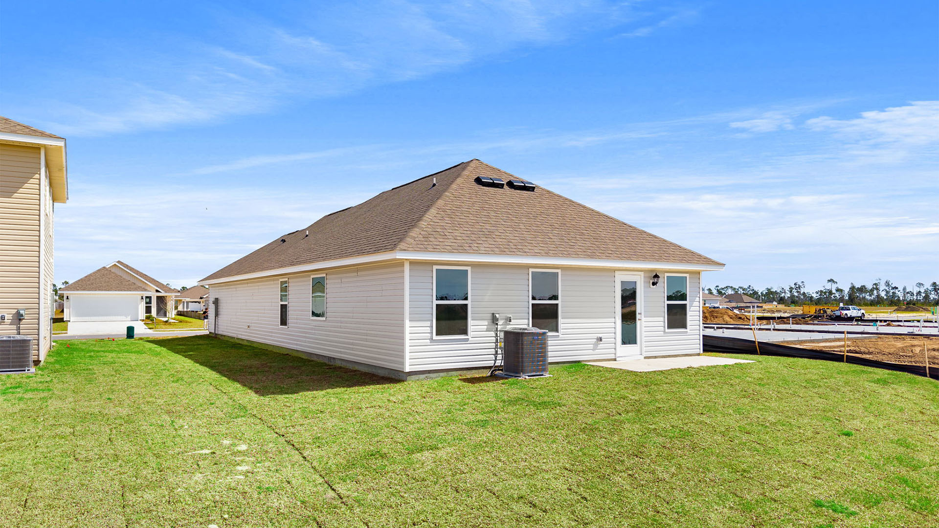 Celeste plan rear of home with concrete pad.