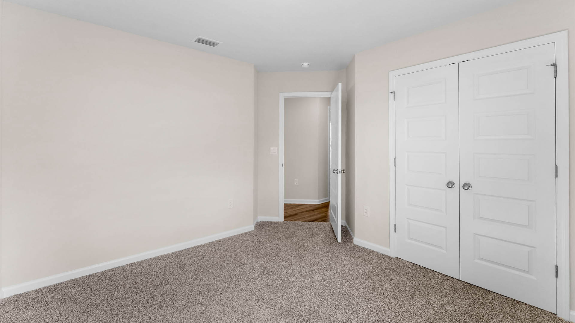 Bedroom with closet and carpet floors.