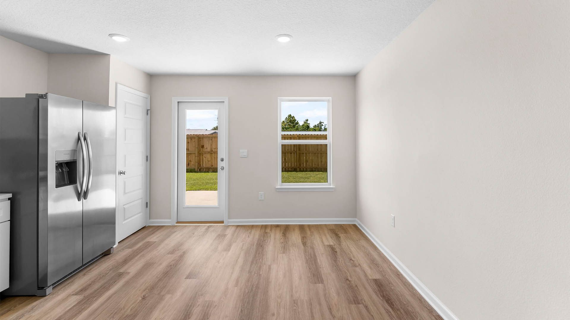 Dining area next to back door in kitchen.