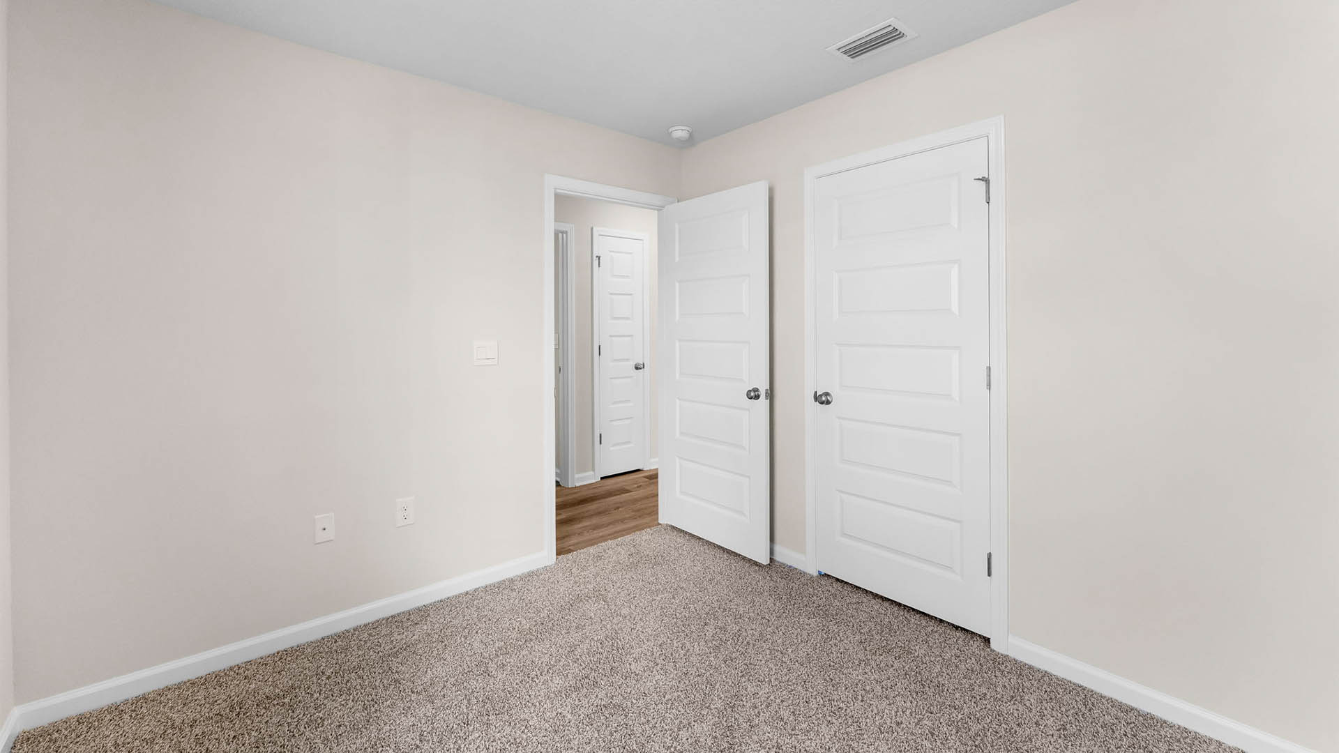 Bedroom with closet and carpet floors.