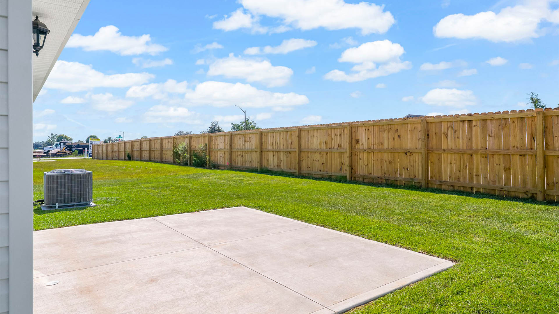Backyard view with concrete pad.