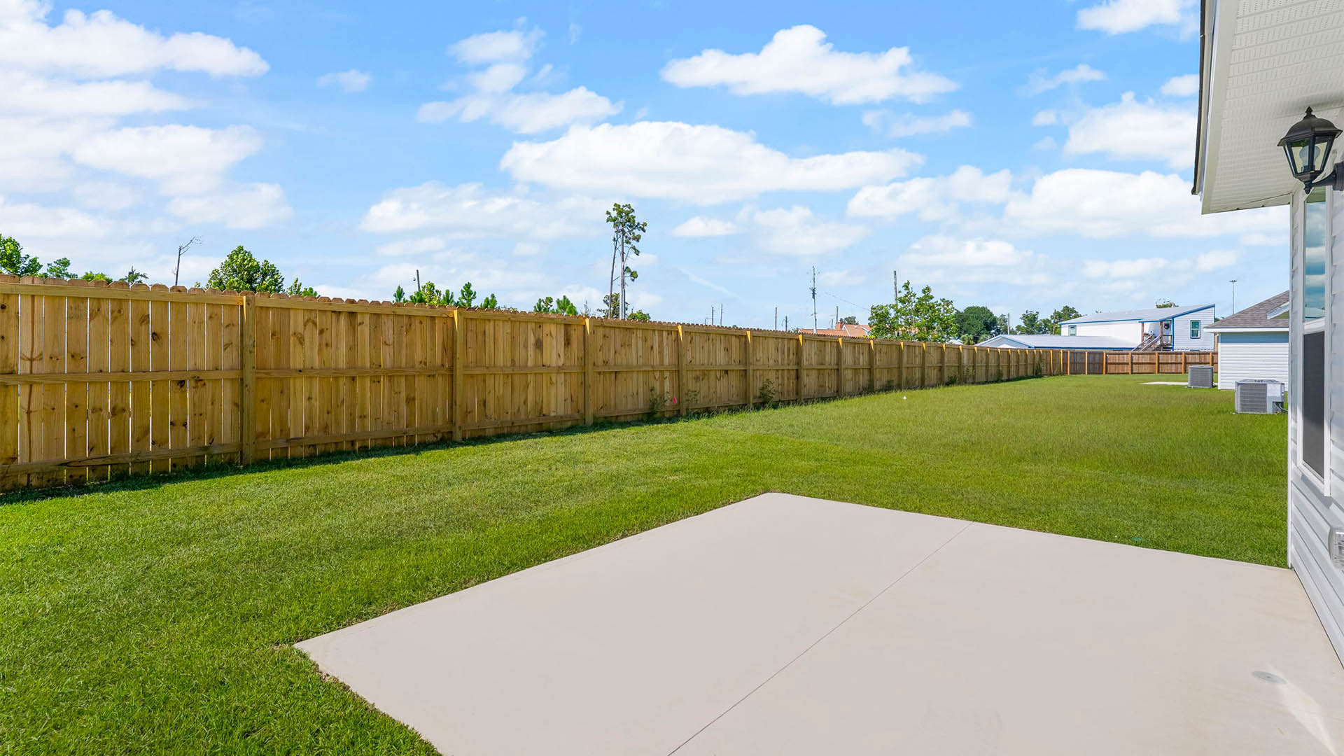 Backyard view with concrete pad.