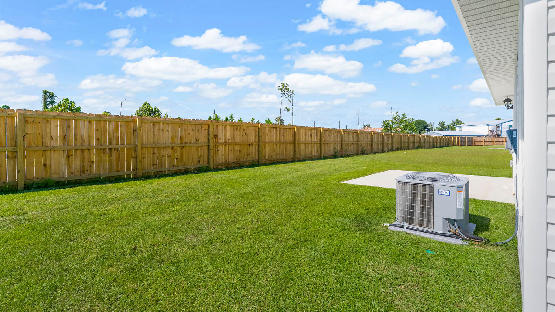 Backyard view with concrete pad.