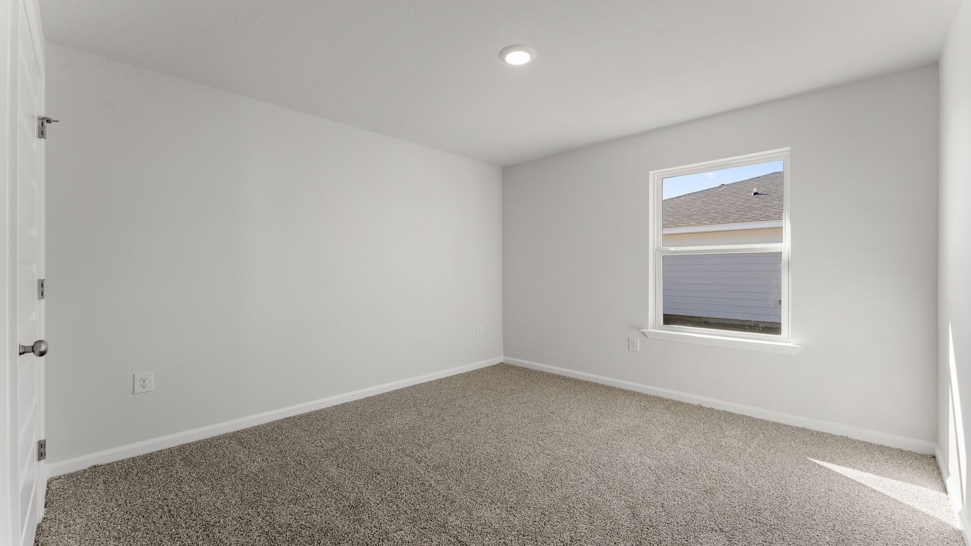 Bedroom with carpet floor and window.